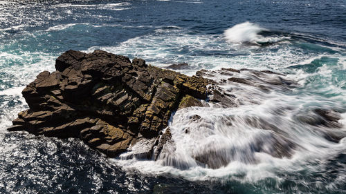 Sea waves splashing on rocks