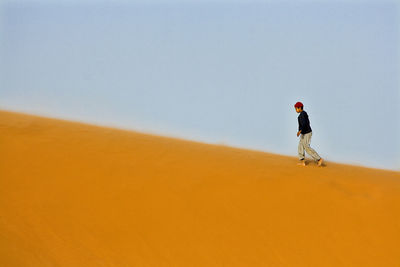 Rear view of man on land against sky