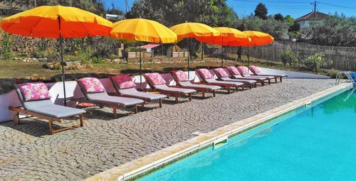 Lounge chairs by swimming pool