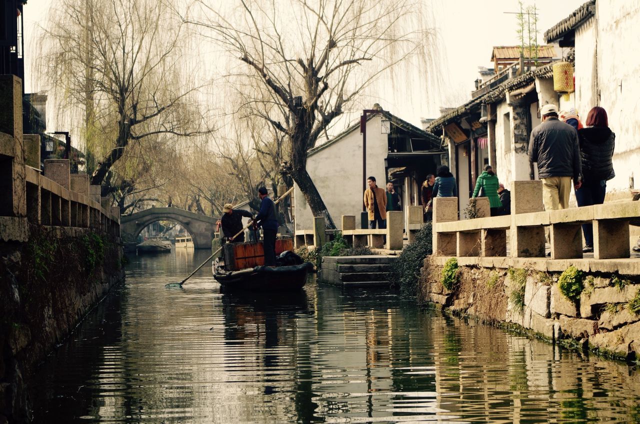 building exterior, architecture, water, built structure, canal, waterfront, reflection, nautical vessel, residential building, residential structure, building, transportation, boat, house, mode of transport, moored, tree, incidental people, day