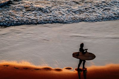 High angle view of man sitting on beach