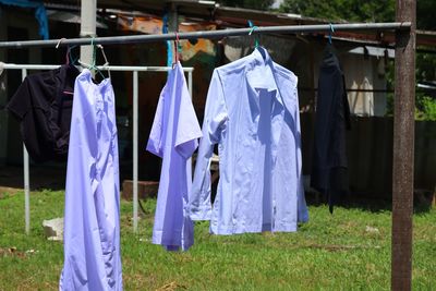 Close-up of clothes drying on field