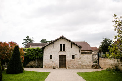 Old stone building inside garden in french countryside