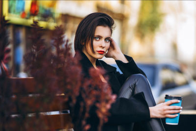 Portrait of young woman looking at camera