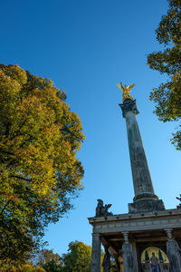 Low angle view of statue against blue sky