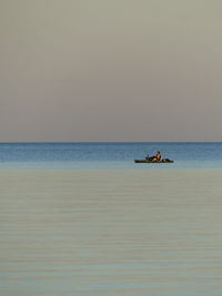 Boat on sea against clear sky