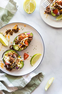 Avocado boats topped with seasoned beef, cheese and tomato.