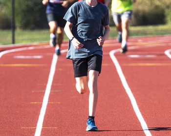 Low section of man running on road