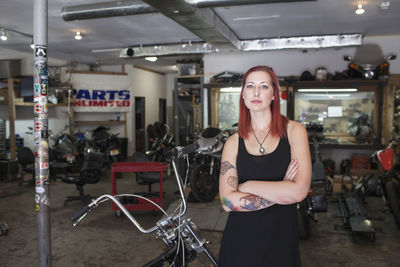 A young woman with a motorcycle.