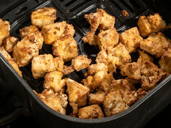 Detailed shot of golden and nutritious tofu cubes perfectly air-fried for a healthy culinary delight