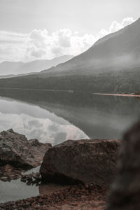 Scenic view of lake and mountains against sky