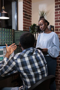 Male and female colleagues discussing in office