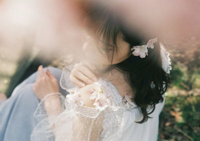 Midsection of woman holding flower bouquet