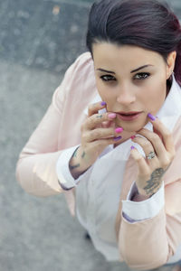 Portrait of beautiful young woman standing on street