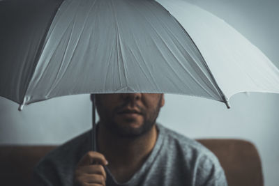 Portrait of man holding umbrella