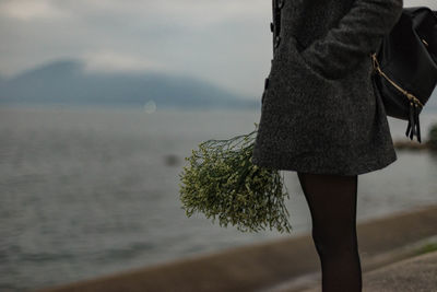 Woman standing by tree