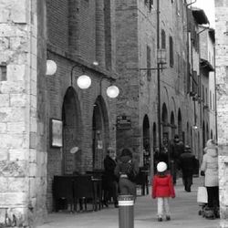 Rear view of people walking on street in winter