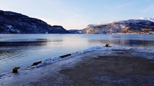 Scenic view of lake against sky during winter