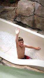 Full length of smiling boy in water