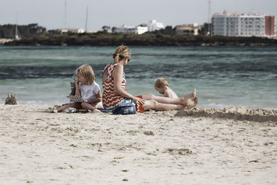 People sitting on shore at beach