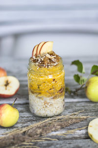 Apple porridge in jar with fruits on table 