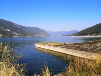 Scenic view of lake against clear blue sky