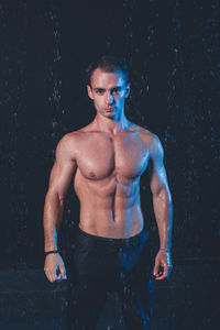 Full length of shirtless man standing in water