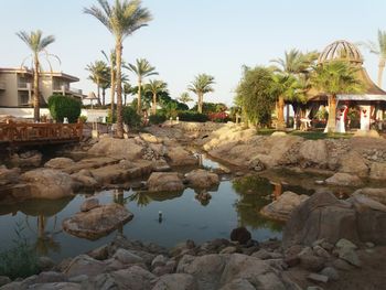 View of swimming pool by lake against sky