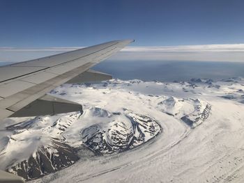 Aerial view of snowcapped mountain against sky