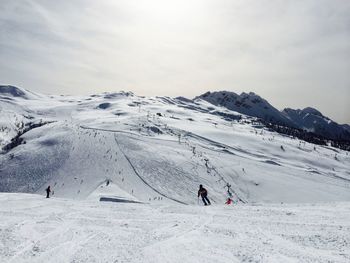 Low angle view of snow covered mountain against sky