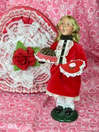 Full length of a girl standing against red wall