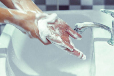 Close-up of hand touching water