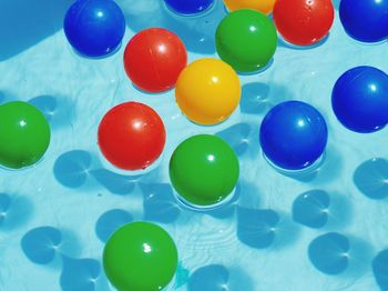 High angle view of colorful balls floating on swimming pool