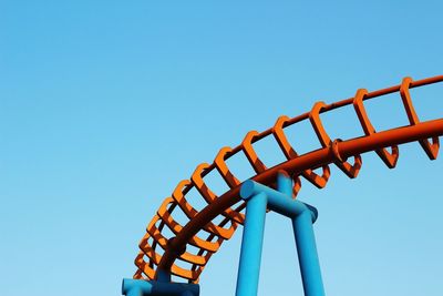 Low angle view of metallic structure against clear blue sky