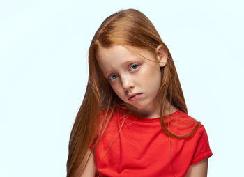 Portrait of young woman against white background