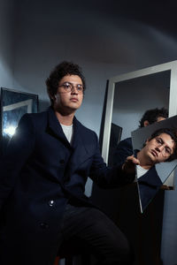 Happy young man sitting at home