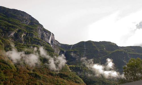 Scenic view of waterfall against sky