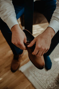 Low section of man sitting on wooden floor