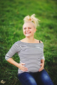 Portrait of smiling girl sitting outdoors