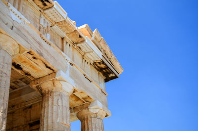 Low angle view of historic building against clear blue sky