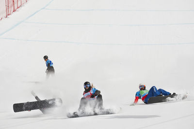 People skiing on snow covered landscape