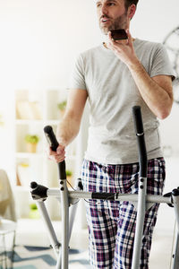Midsection of man standing at home