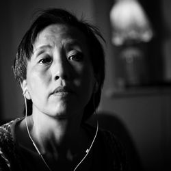 Close-up portrait of mid adult chinese woman at home