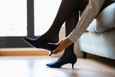 Low section of ballet dancer dancing on floor