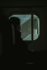 Man sitting by window in train