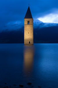 Bell tower in sea at night