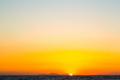 Scenic view of sea against orange sky