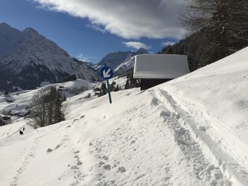 Scenic view of snow covered mountains against sky