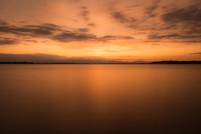 Scenic view of sea against orange sky