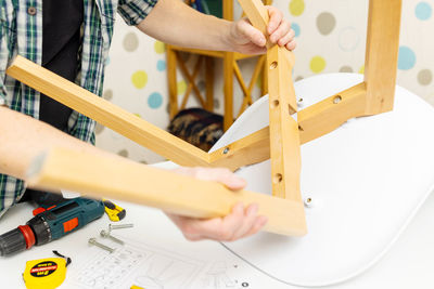 Cropped hand of man working on table